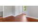 Spacious bedroom with hardwood floors, light gray walls, and a white door at 134 Nelson St, Durham, NC 27707