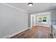 Spacious dining area with gray walls, hardwood flooring, and adjacent rooms at 134 Nelson St, Durham, NC 27707