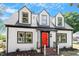 Charming two-story home featuring a bright red front door and well-maintained landscaping at 134 Nelson St, Durham, NC 27707
