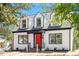 Beautiful two-story home with dormer windows, a red door, and manicured front lawn at 134 Nelson St, Durham, NC 27707