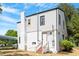 Two-story home featuring a white exterior with a brick chimney and a walk-up entrance at 134 Nelson St, Durham, NC 27707
