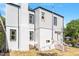 Two-story home featuring a white exterior with a brick chimney and a walk-up entrance at 134 Nelson St, Durham, NC 27707