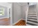 Hallway featuring hardwood floors, white trim, and view to upstairs stairway at 134 Nelson St, Durham, NC 27707