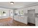 Well-lit kitchen with sleek countertops, ample cabinetry, and hardwood style flooring at 134 Nelson St, Durham, NC 27707