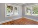 Inviting living room featuring hardwood floors, light gray walls, and bright windows at 134 Nelson St, Durham, NC 27707