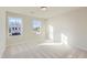 Bright bedroom with neutral carpet and large windows providing plenty of natural light at 136 N Finley Landing Parkway, Smithfield, NC 27577