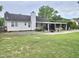 Expansive backyard featuring a covered patio, well-maintained lawn and mature trees at 1360 Honeycutt Rd, Willow Springs, NC 27592