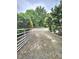 Long gravel driveway leading to wooded property with mature trees and ample parking at 1360 Honeycutt Rd, Willow Springs, NC 27592