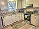 Functional kitchen with stainless steel appliances, tile countertops, and ample cabinet space at 1360 Honeycutt Rd, Willow Springs, NC 27592