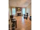 Cozy living room featuring a stone fireplace, wood floors, and bright windows at 1360 Honeycutt Rd, Willow Springs, NC 27592