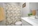 Well-lit bathroom featuring a vanity with storage, a framed mirror, and a shower with patterned curtain at 1515 Millrock Trl, Wendell, NC 27591