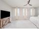 Spacious bedroom featuring neutral tones, ceiling fan, and ample natural light from three windows at 1515 Millrock Trl, Wendell, NC 27591