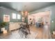 Open-concept dining area with stylish table set, chandelier, and views into modern kitchen at 1515 Millrock Trl, Wendell, NC 27591