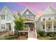 Charming two-story home showcasing a red door, inviting front porch and well-maintained lawn and landscaping at 1515 Millrock Trl, Wendell, NC 27591