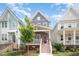 Charming two-story home showcasing a red door, inviting front porch and well-maintained lawn and landscaping at 1515 Millrock Trl, Wendell, NC 27591