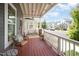 Inviting front porch featuring a cozy seating area, charming railings, and views of a quiet street at 1515 Millrock Trl, Wendell, NC 27591