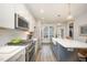 Modern kitchen boasts stainless appliances, white cabinets, a large island with seating, and trendy pendant lights at 1515 Millrock Trl, Wendell, NC 27591