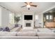 Bright living room showcasing a fireplace, ceiling fan and comfortable seating area with a neutral color palette at 1515 Millrock Trl, Wendell, NC 27591