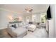 Bright living room showcasing a fireplace, ceiling fan and comfortable seating area with a neutral color palette at 1515 Millrock Trl, Wendell, NC 27591