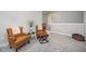 Cozy sitting area with comfortable leather chairs, an ottoman, and neutral decor creating a relaxing atmosphere at 1515 Millrock Trl, Wendell, NC 27591