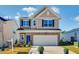 Charming two-story home featuring a two-car garage and stone accents at 160 N Finley Landing Pkwy, Smithfield, NC 27577