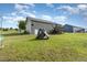 Large backyard showcasing a deck, play structure, and well-maintained lawn, ideal for outdoor activities and Gathering enjoyment at 18 Hunter Fox Trl, Angier, NC 27501