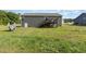 Spacious backyard featuring a wooden deck with stairs, lush lawn, and play equipment, perfect for outdoor living at 18 Hunter Fox Trl, Angier, NC 27501