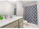 Bathroom featuring a single sink with gray cabinets and a shower/tub combo at 18 Hunter Fox Trl, Angier, NC 27501