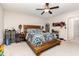 Spacious bedroom with wooden platform bed, ceiling fan, and ample natural light at 18 Hunter Fox Trl, Angier, NC 27501