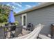 Outdoor deck with seating, grill, umbrella, and a relaxing hammock at 18 Hunter Fox Trl, Angier, NC 27501
