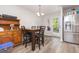 Bright dining area featuring hardwood floors, stylish table, and convenient access to the backyard at 18 Hunter Fox Trl, Angier, NC 27501