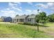 Well-maintained lawn and quaint one-story house with inviting front porch at 18 Hunter Fox Trl, Angier, NC 27501
