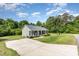 Well-manicured lawn and long driveway lead to this cozy one-story home with inviting front porch at 18 Hunter Fox Trl, Angier, NC 27501