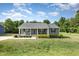Charming one-story home with inviting front porch and well-maintained lawn and landscaping at 18 Hunter Fox Trl, Angier, NC 27501