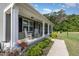 Inviting front porch with rocking chairs and lovely landscaping at 18 Hunter Fox Trl, Angier, NC 27501