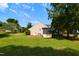 View of the home's backyard featuring a shed, an air conditioning unit, and a well-maintained lawn with trees at 200 Steeple Rd, Holly Springs, NC 27540