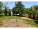 A backyard offers landscaping including small trees and lawn at 200 Steeple Rd, Holly Springs, NC 27540