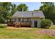 A backyard offers a stained deck with space for outdoor dining at 200 Steeple Rd, Holly Springs, NC 27540