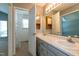 Bright bathroom featuring double sink vanity, mirror, and walk-in closet at 200 Steeple Rd, Holly Springs, NC 27540