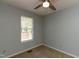 This bedroom offers a large window with natural light and a ceiling fan at 200 Steeple Rd, Holly Springs, NC 27540