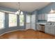 Eat in kitchen offers ample natural light, stainless appliances, and stylish blue cabinets, a perfect blend of functionality at 200 Steeple Rd, Holly Springs, NC 27540