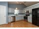 Bright kitchen with stainless appliances, light gray cabinets, and durable wood-look flooring at 200 Steeple Rd, Holly Springs, NC 27540