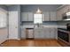 Well-equipped kitchen with stainless steel appliances, ample cabinet space, and wood-look flooring at 200 Steeple Rd, Holly Springs, NC 27540