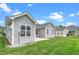 Gray home exterior, with green grass and a cloudy blue sky at 2033 Buck Corner Ln, Fuquay Varina, NC 27526