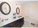 Well-lit bathroom featuring double sinks, granite countertops, and dual mirrors at 2033 Buck Corner Ln, Fuquay Varina, NC 27526