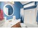 Well-lit bathroom with vanity, tub, and blue accent wall at 2033 Buck Corner Ln, Fuquay Varina, NC 27526