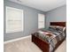 Cozy bedroom featuring a wooden bed frame and natural light streaming through the windows at 2033 Buck Corner Ln, Fuquay Varina, NC 27526
