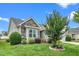 Charming home featuring stone accents, manicured lawn, and mature landscaping, providing a welcoming exterior at 2033 Buck Corner Ln, Fuquay Varina, NC 27526