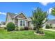 Charming home featuring stone accents, manicured lawn, and beautiful landscaping at 2033 Buck Corner Ln, Fuquay Varina, NC 27526