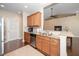 Bright kitchen featuring stainless steel appliances, granite countertops, and wood cabinets at 2033 Buck Corner Ln, Fuquay Varina, NC 27526